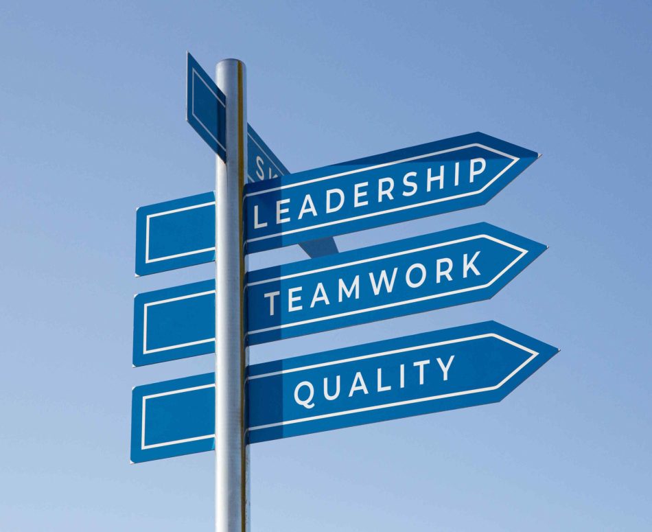 Leadership, teamwork and quality words on signpost isolated on sky background. Management success concept